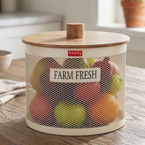 The empty cream mesh vegetable basket shown against a plain white background with its round wooden knob lid leaning