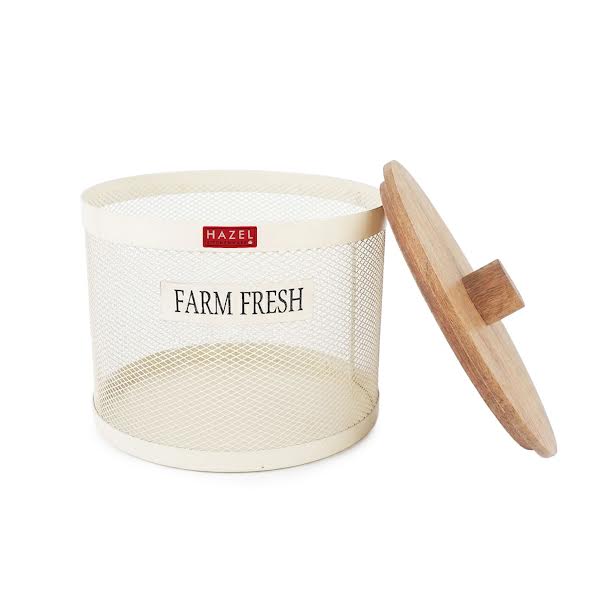 The cream mesh vegetable basket brims with fresh vegetables including cauliflower, tomatoes, beetroot and capsicum