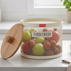 A person's hands hold the cream mesh vegetable basket with its wooden lid
