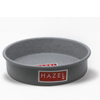 Empty grey non-stick round cake mould shot at a three-quarter angle on a plain white background.