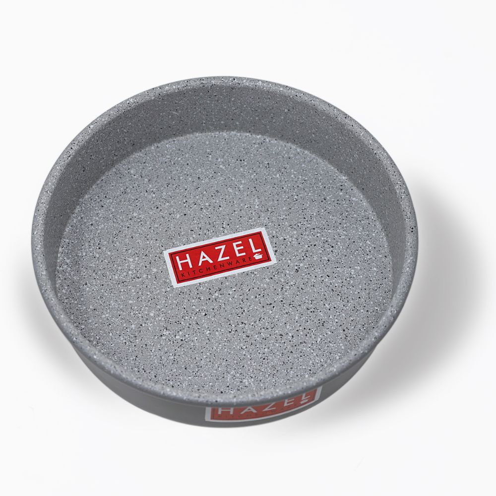 Empty grey non-stick round cake mould shot from a higher top-down angle on a plain white background.