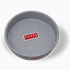 Empty grey non-stick round cake mould shot from a higher top-down angle on a plain white background.