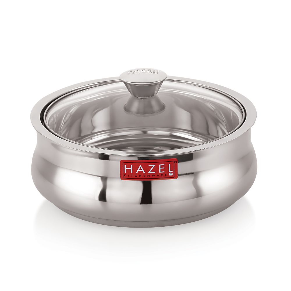 Stainless steel casserole with transparent glass lid on, shown on a white background.