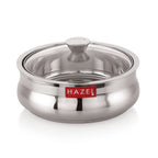 Stainless steel casserole with transparent glass lid on, shown on a white background.
