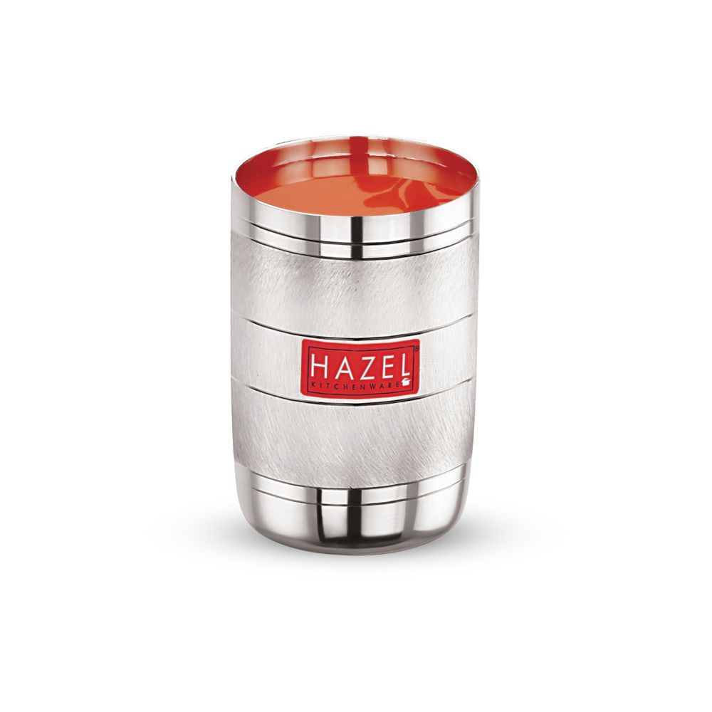 Steel glass filled with a reddish beverage, front view on a plain white background.