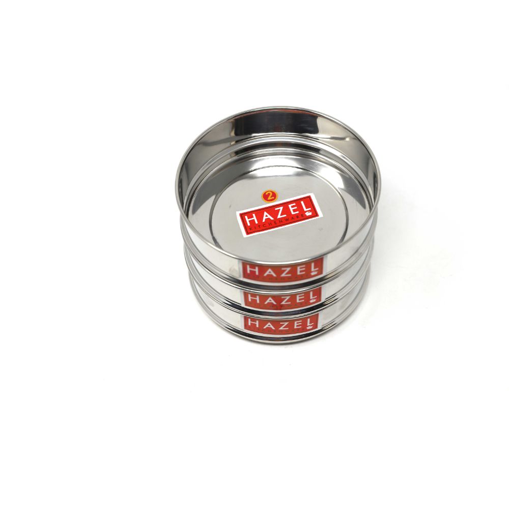 Three stacked empty stainless steel dabbas on a white background.