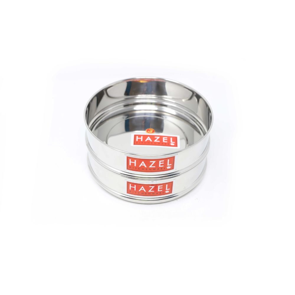 Two empty stainless steel flat dabbas nested tightly together, shown on a plain white background.