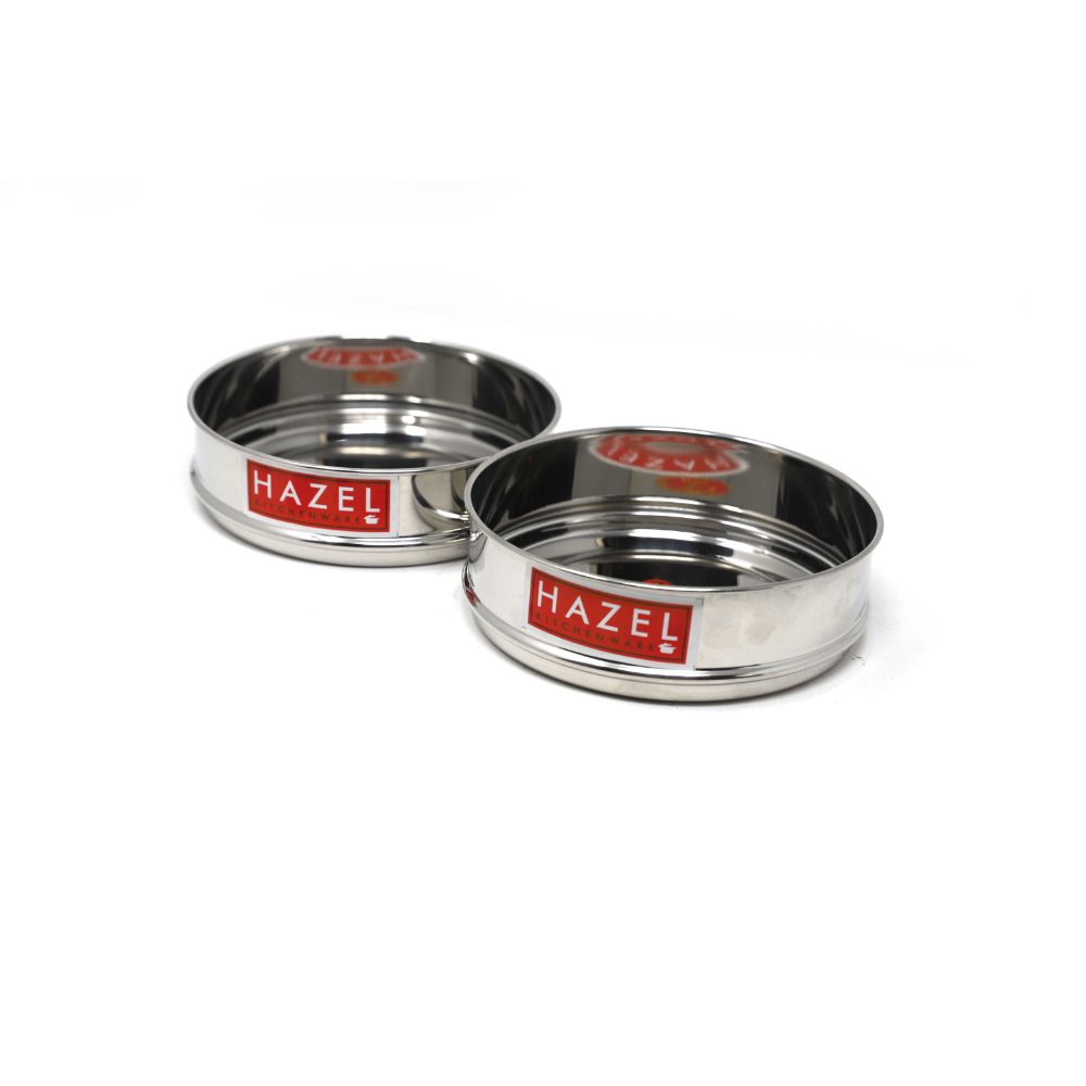 Two empty stainless steel flat dabbas placed side by side at a slightly different offset, shown on a plain white background.