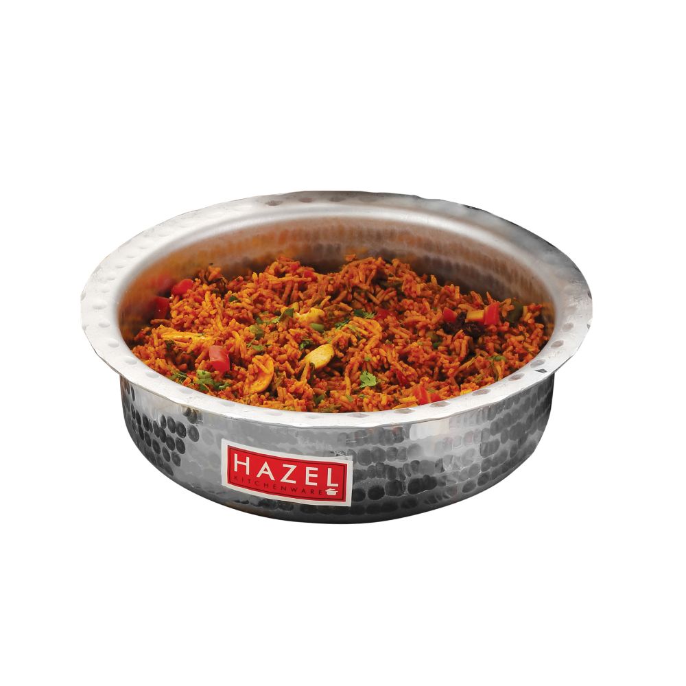 Hammered aluminium patila filled with vegetable curry, shown without its lid on a plain white background.
