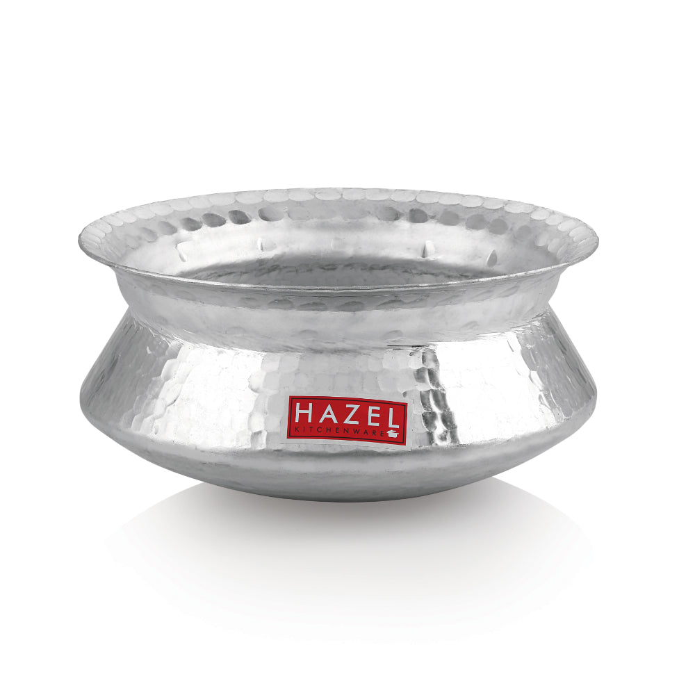 Hammered aluminium degri pot without its lid on a plain white background.