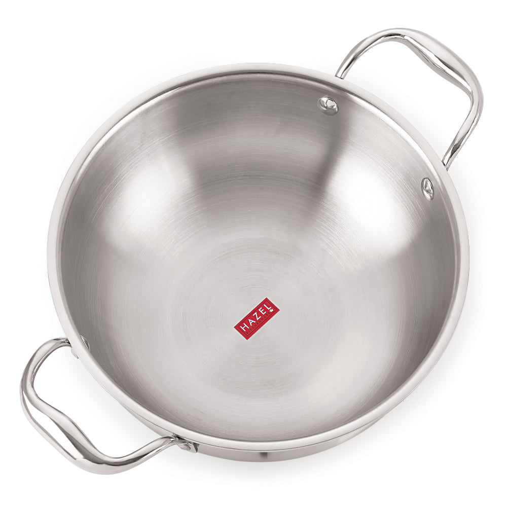 Single triply steel kadhai with two side handles viewed from a raised angle on white.