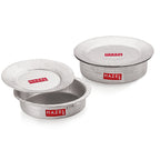 Set of aluminium hammered patilas with lids in two sizes, stacked and arranged together on a white background.