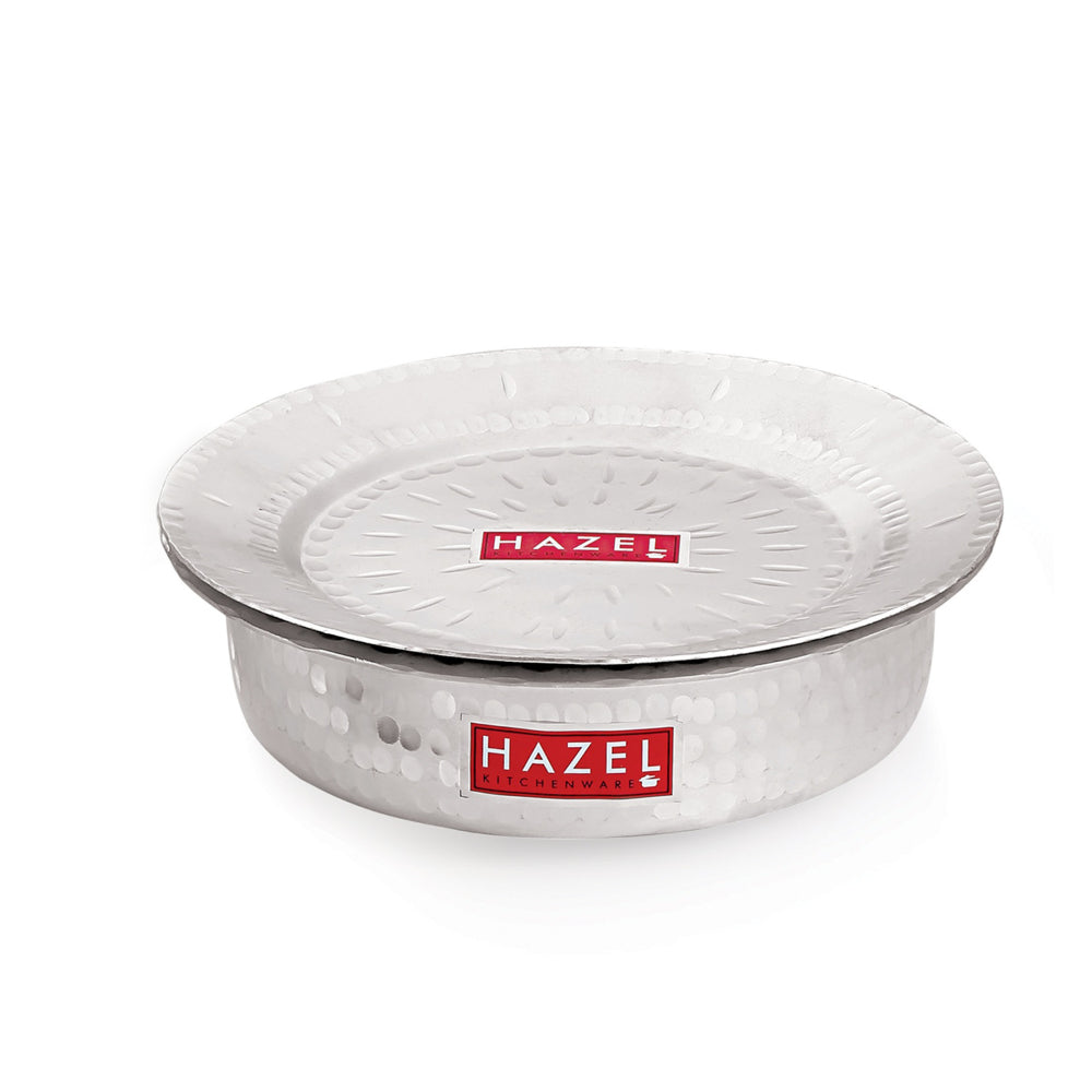 Single hammered aluminium pot with its lid on, shown at a front angle on a plain white background, highlighting.