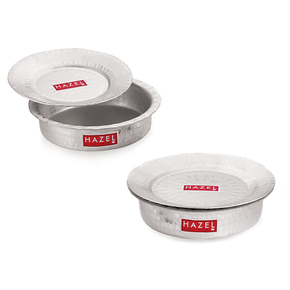 Two aluminium hammered patilas with lids stacked and shown together on a white background.