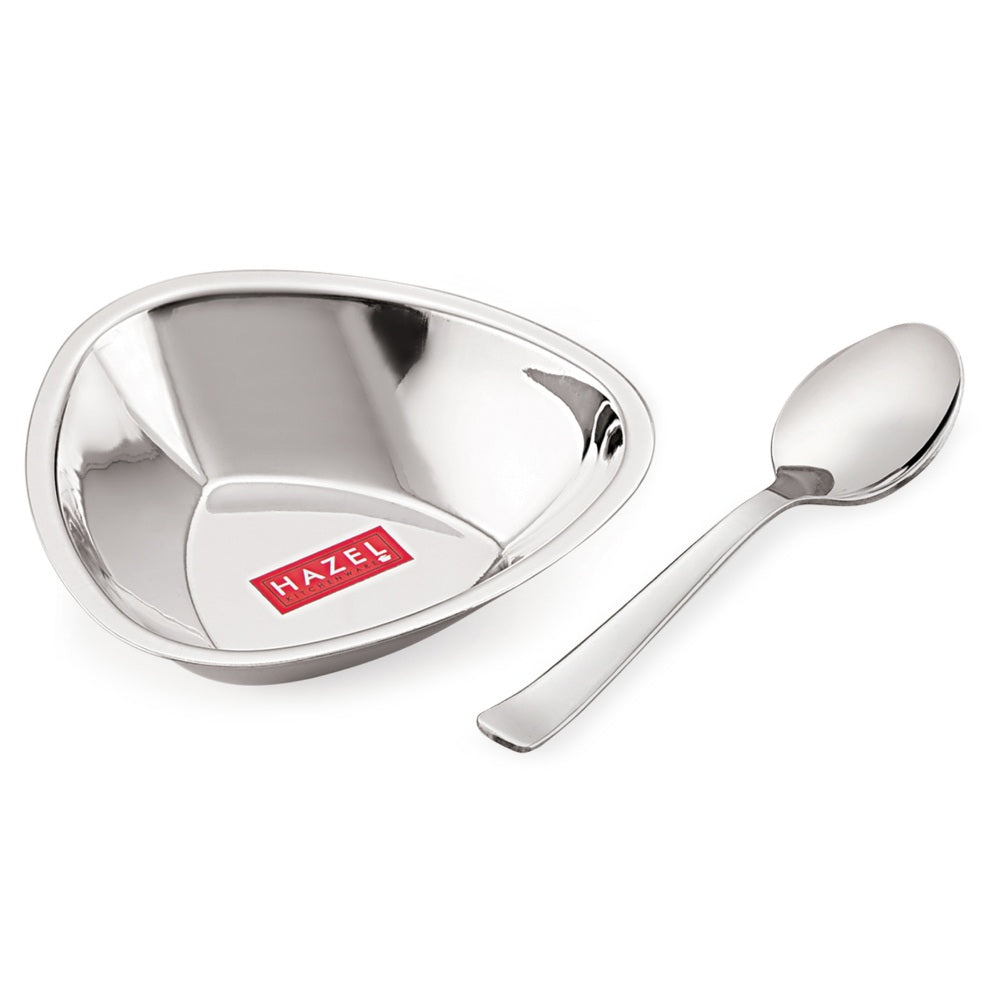 Triangular steel bowl shown at an angle with a spoon alongside on a white background.