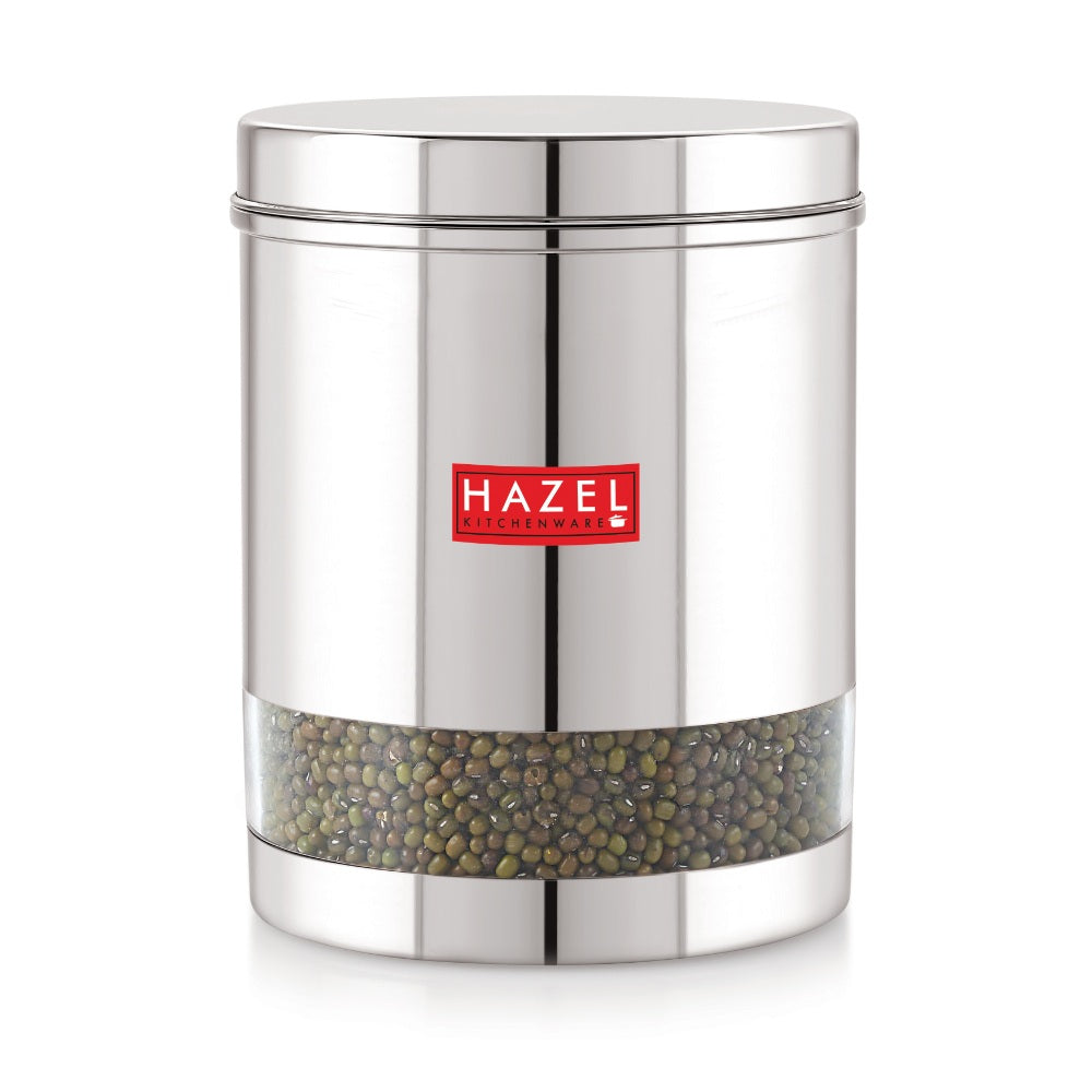 Single storage dabba with steel lid and green pulses visible through the transparent lower window, on a plain.