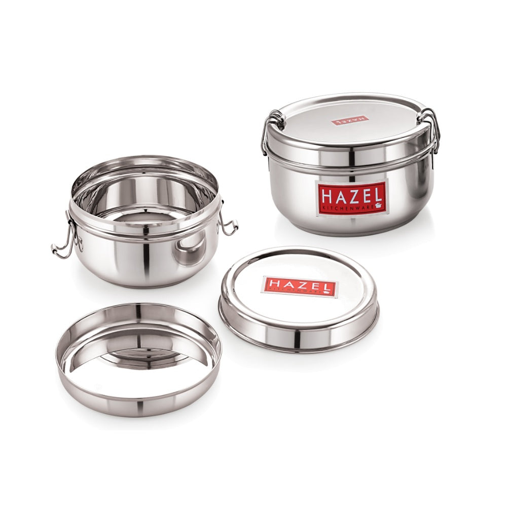 Stacked stainless steel tiffin box with a separate lid and ring on a plain white background.