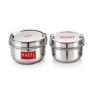 Two closed stainless steel tiffin boxes with locking clips side by side on white.