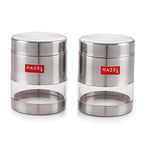Two empty matte steel containers with clear windows shown side by side on white.