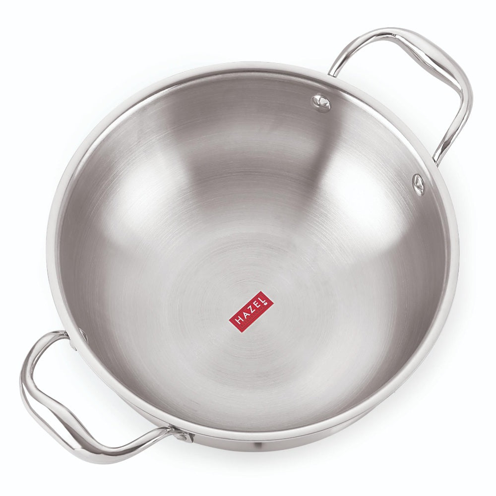 Empty stainless steel triply induction kadai with two riveted steel handles shown on a plain white background.