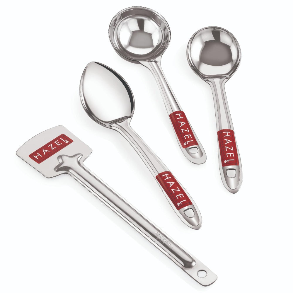 The four steel utensils (turner, two ladles, serving spoon) arranged side by side on a white background.