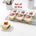 Gold foil containers of dessert topped with strawberries on a cooling rack, with red text Set of 10 Pcs.