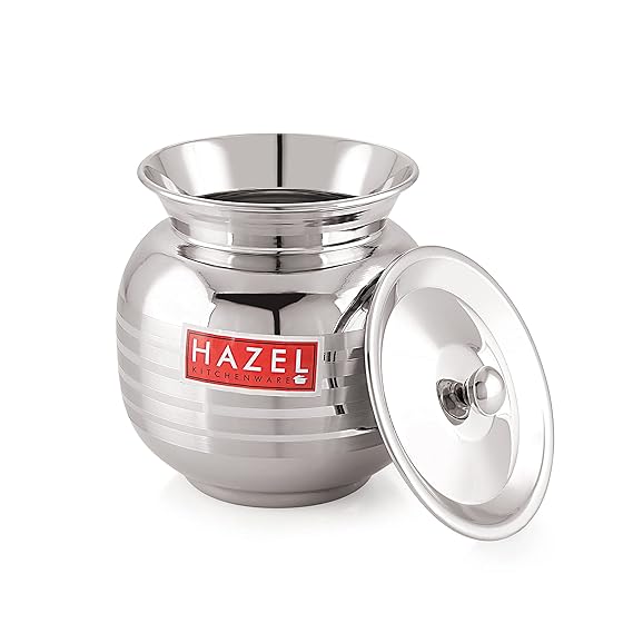 Stainless steel lota with lid propped alongside