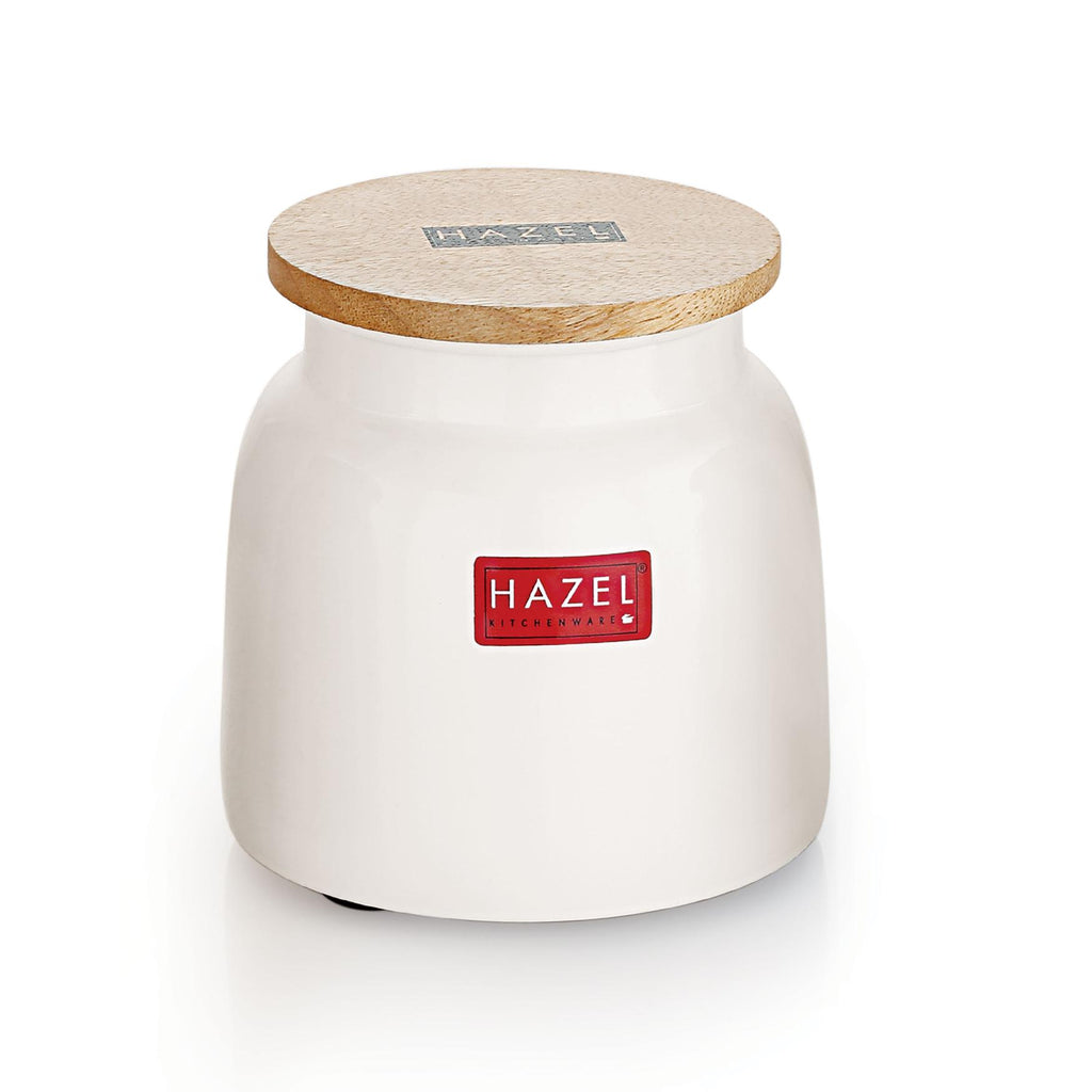 White ceramic storage jar with wooden lid closed on top, shown at a clean front angle on a plain white background.