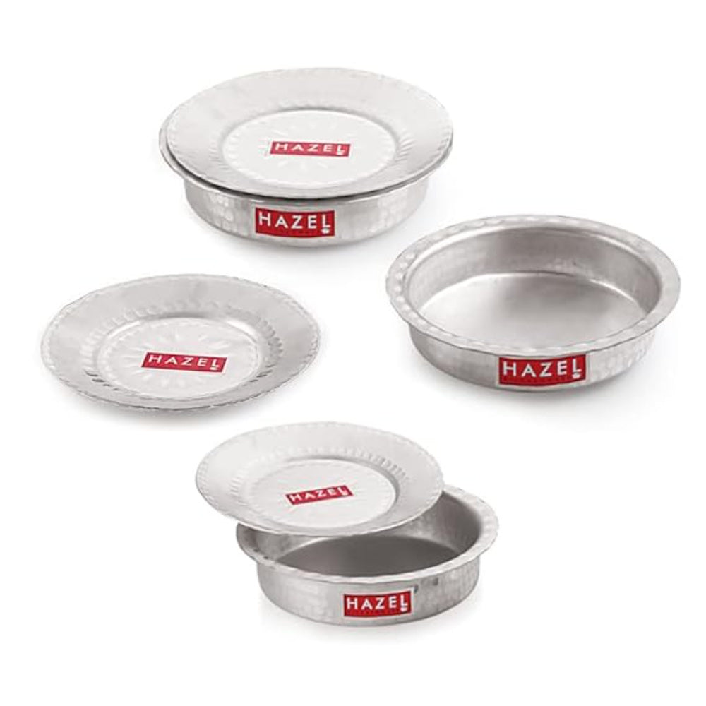 Set of three aluminium hammered patila dishes with lids arranged on a white background.
