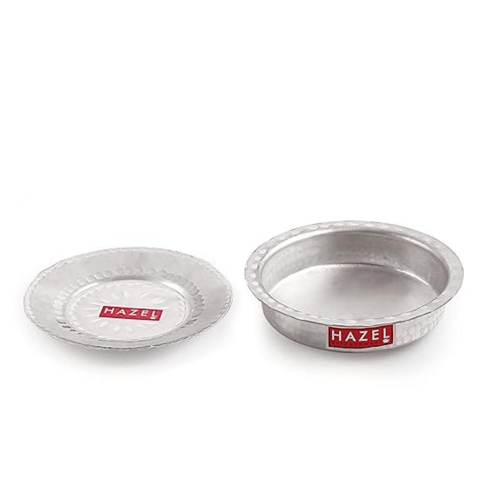 An aluminium hammered dish and its lid shown on a dark grey surface.