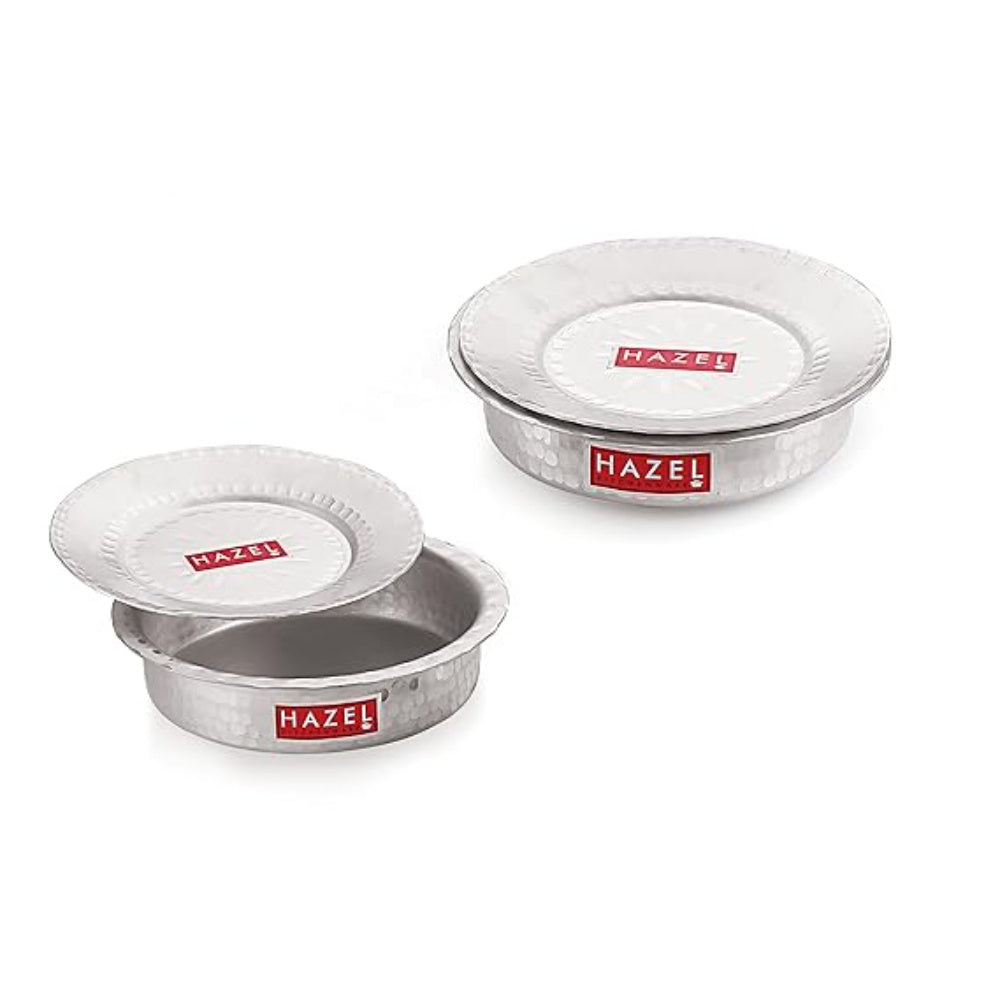 Two aluminium hammered topes with lids stacked at an angle on a white background.