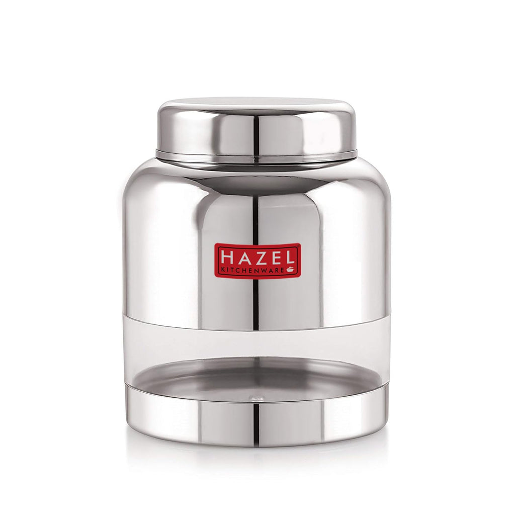 The stainless steel container filled with red lentils, lid removed and resting beside it, shown at an angle on a.