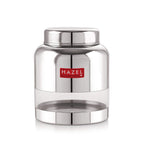 The stainless steel container filled with red lentils, lid removed and resting beside it, shown at an angle on a.