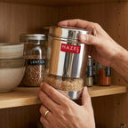 Single closed steel wide-mouth container with transparent base, shown front-on against a white background.