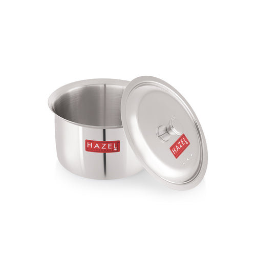 The empty stainless steel patila with its lid leaning against it, shown on a plain white background with red HAZEL labels.
