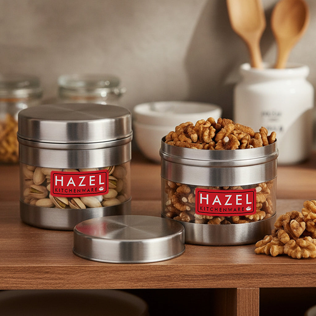 Stainless steel storage container with transparent section shown in a kitchen setting.