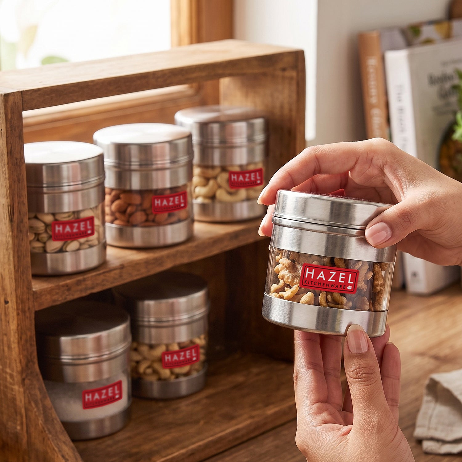 Stainless steel storage container with transparent section shown from a front three-quarter angle.