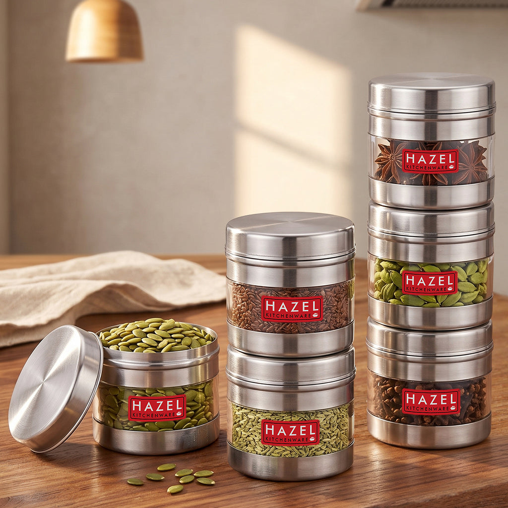 Stainless steel storage container with transparent section shown in a kitchen setting.