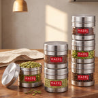 Stainless steel storage container with transparent section shown in a kitchen setting.