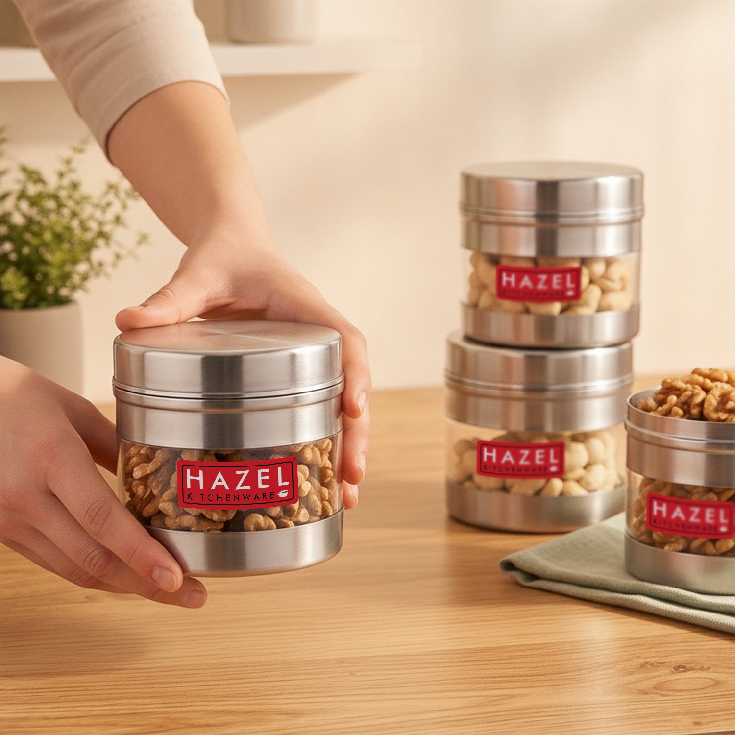 Stainless steel storage container with transparent section shown from a front three-quarter angle.