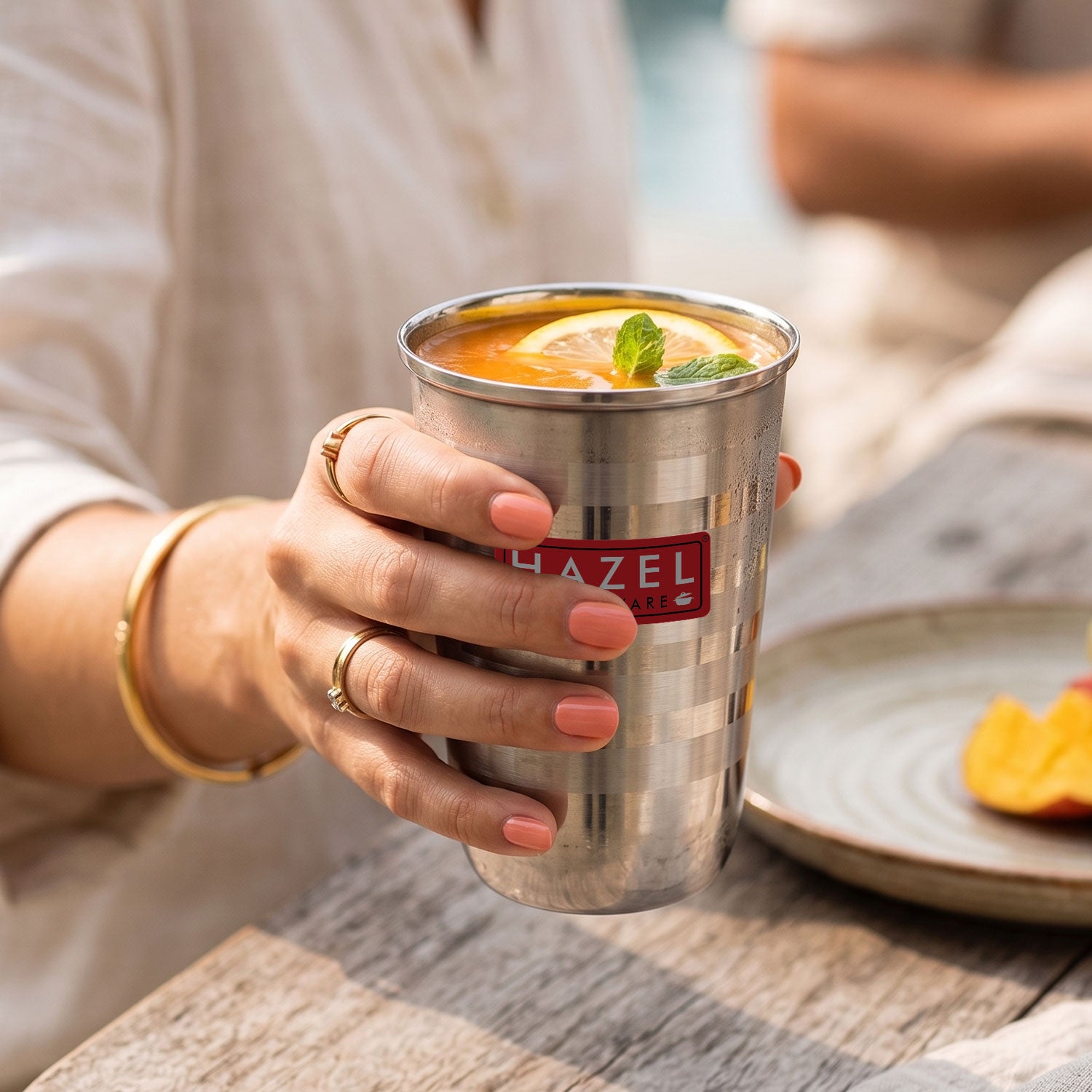 Stainless Steel Water Glass, Juice & Milk Cups, 250ml, Set of 12 shown in a kitchen scene.