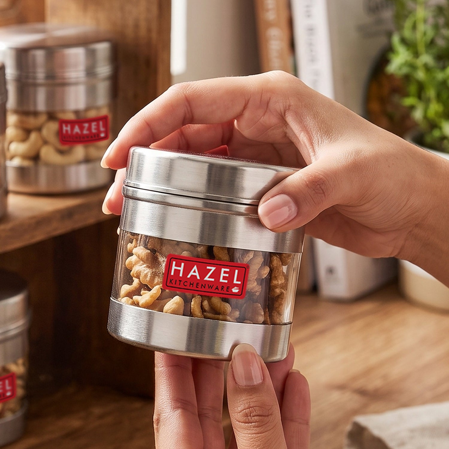 Stainless steel storage container with transparent section shown from a front three-quarter angle.