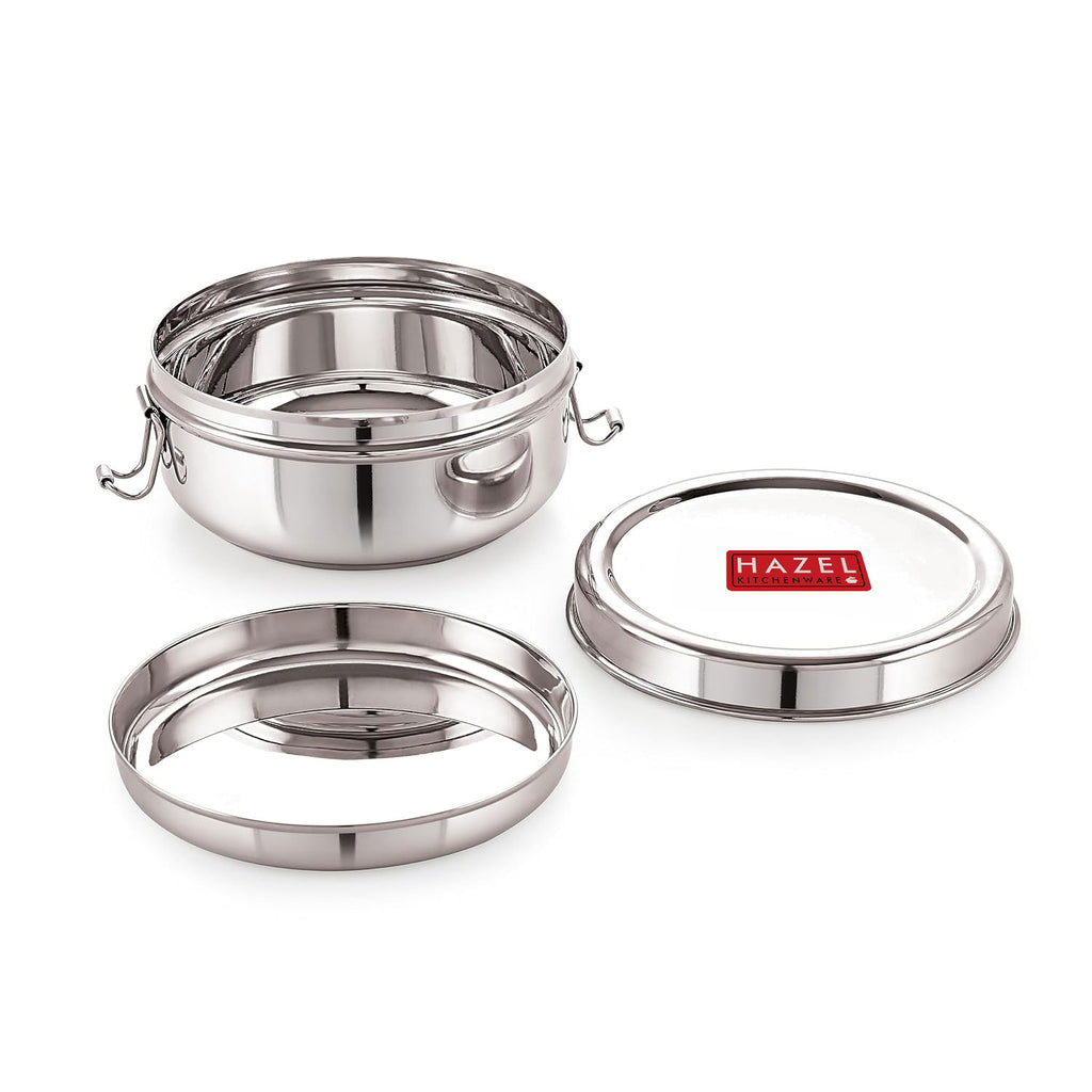 Single closed stainless steel lunch box with locking clips, shown front-facing on a white background.